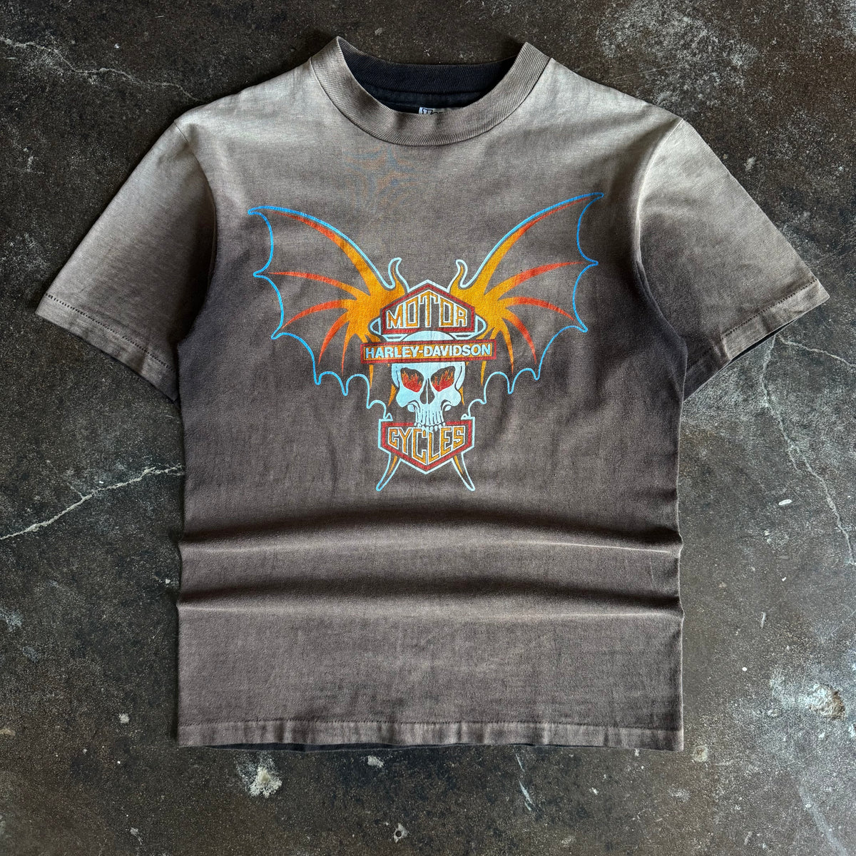 Black short-sleeve t-shirt with orange and red bat-winged skull graphic, Denver CO text on chest