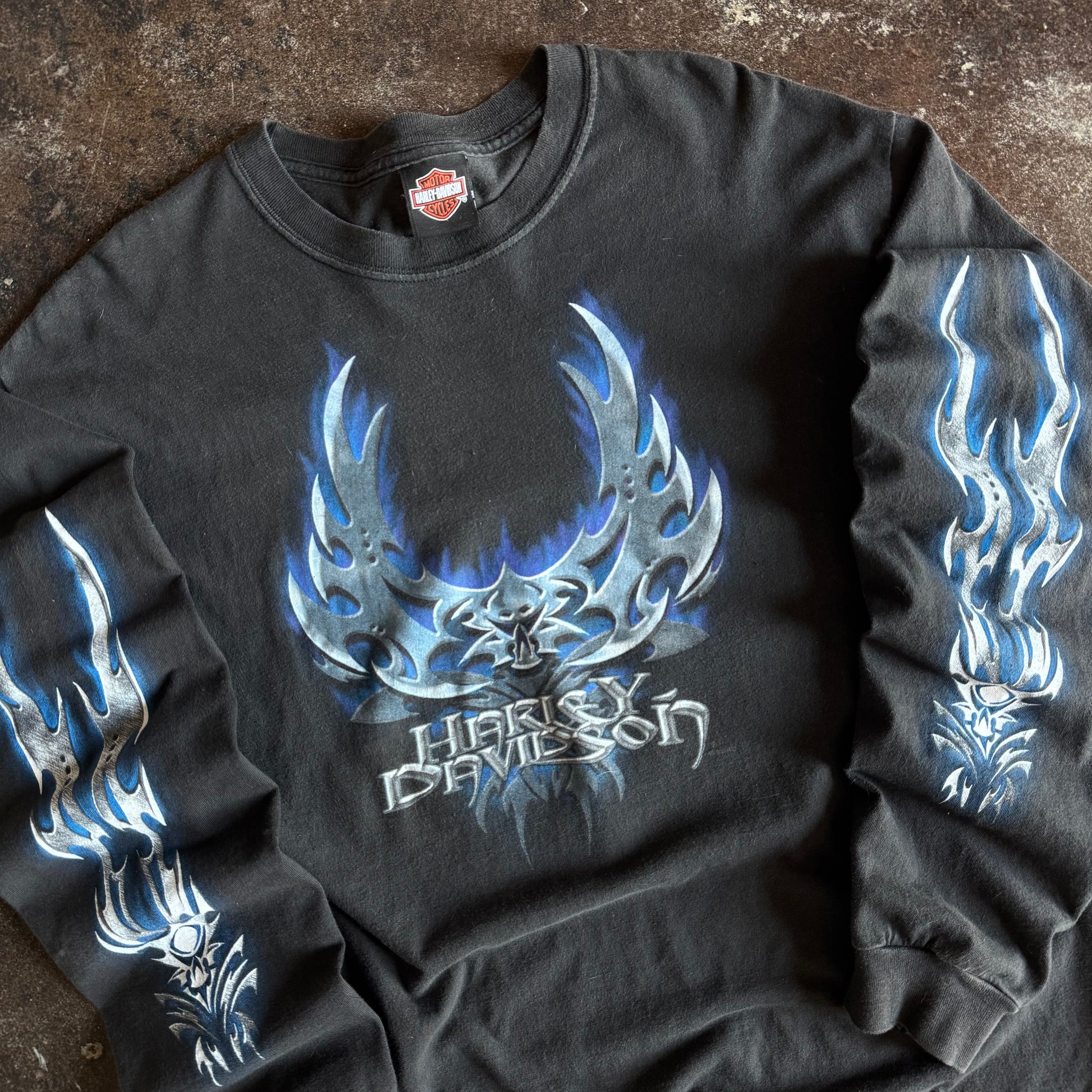 Detail of blue chrome blade flames and skull on vintage Harley longsleeve