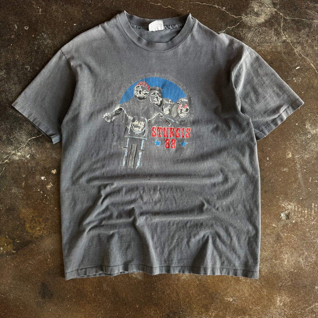 Vintage 1988 Sturgis Rally t-shirt with biker faces on Mount Rushmore and chopper rider on sun faded grey