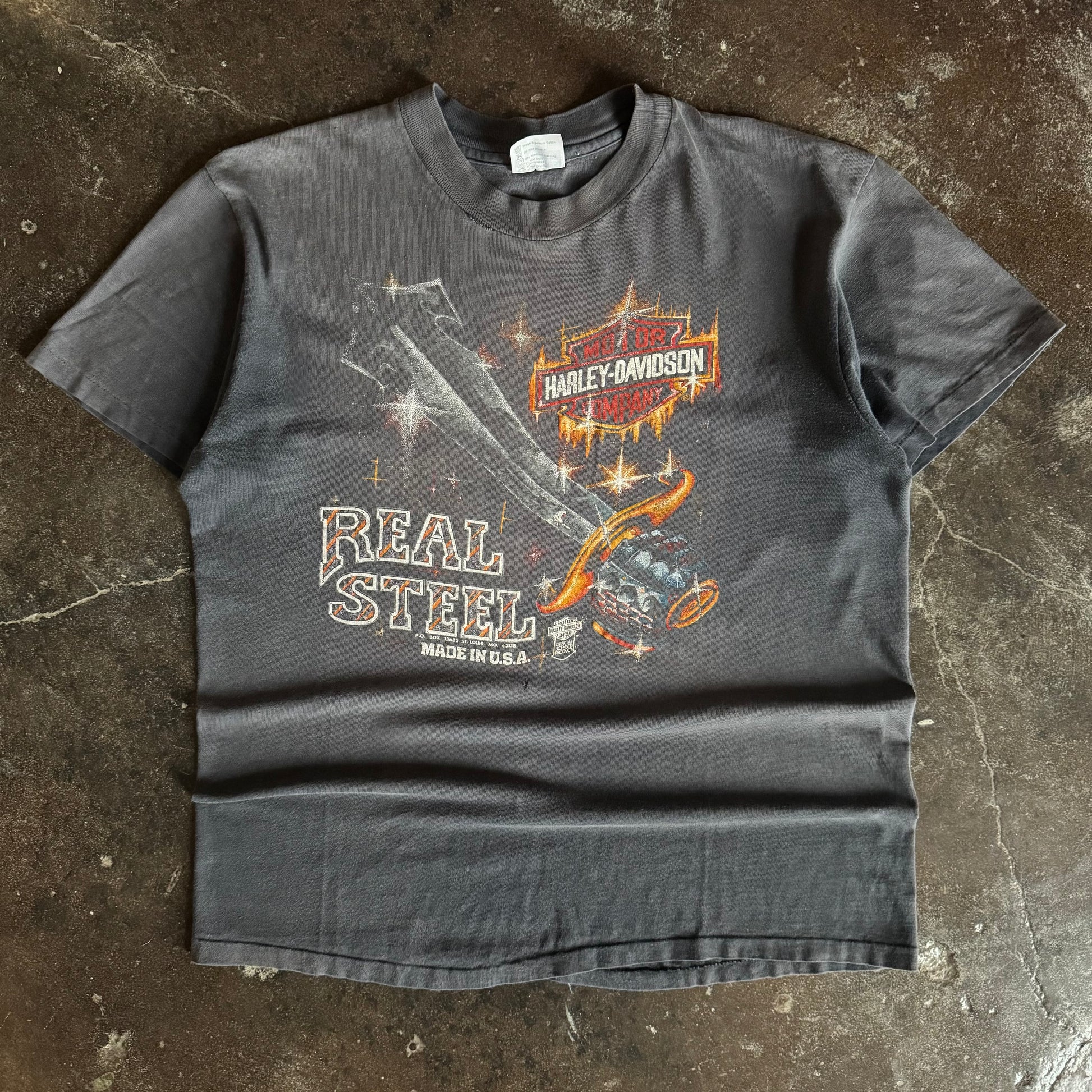 Black short-sleeve t-shirt with Real Steal and Iowa text graphic, sun faded condition