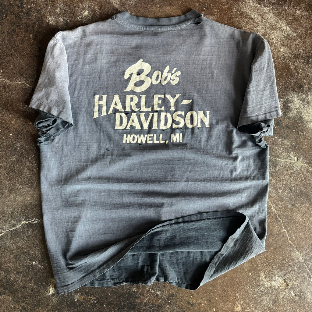 Detail of 75 Years wings emblem on vintage thrashed Harley-Davidson tee