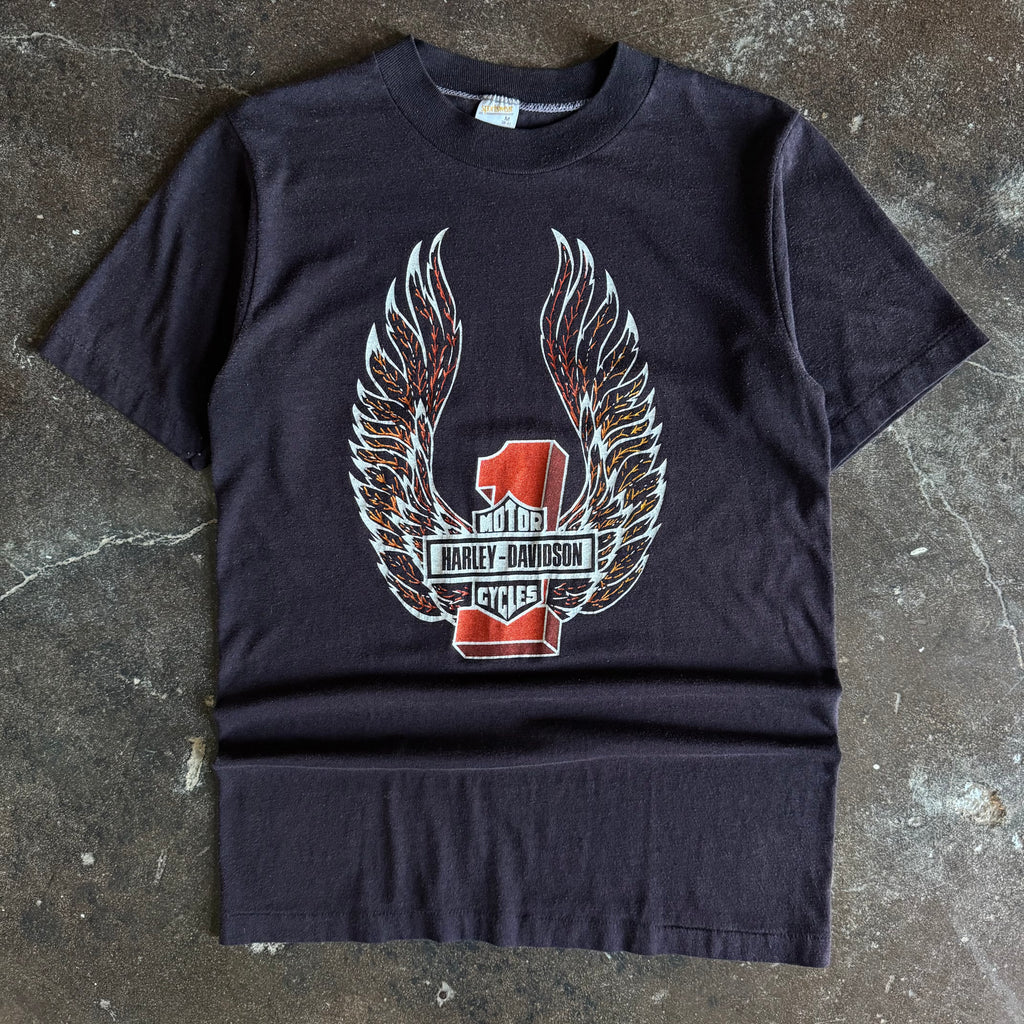 Black short-sleeve t-shirt with centered Harley-Davidson winged emblem graphic and Texas text