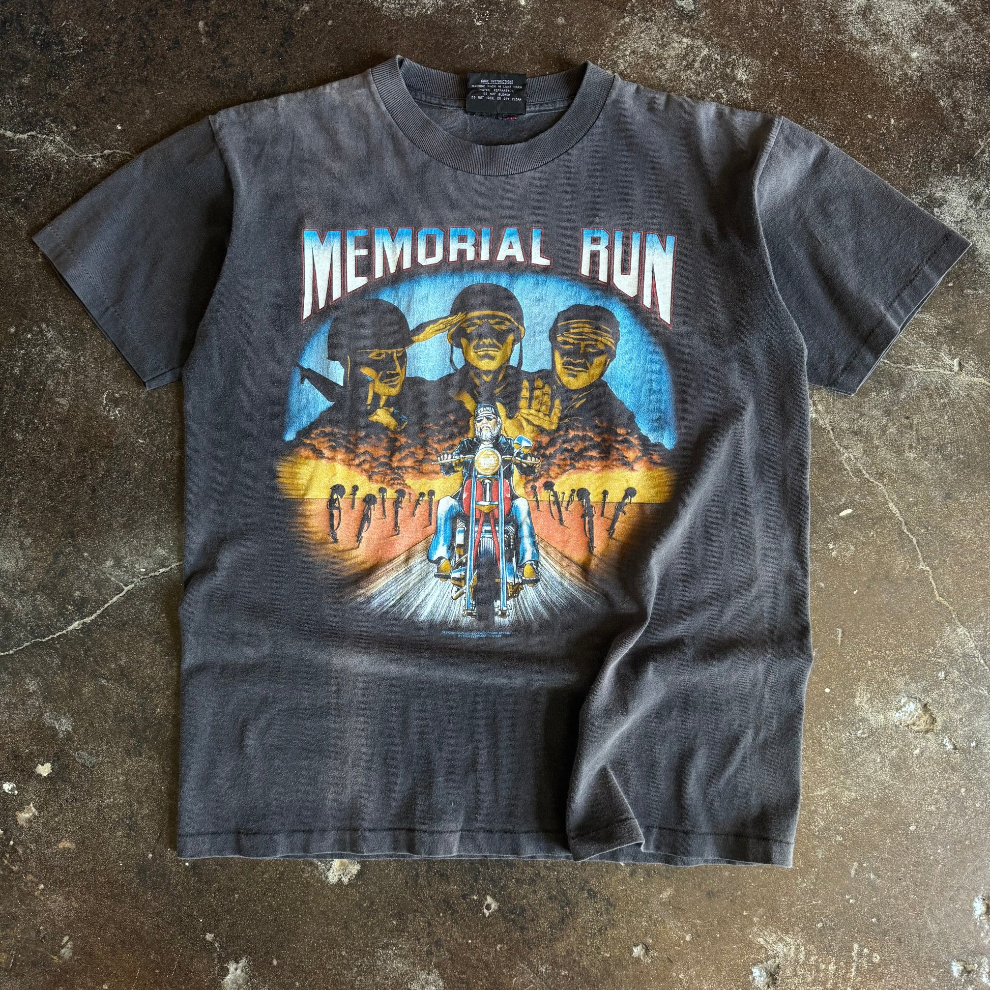 Vintage 1990s Biker Memorial Run t-shirt with military soldiers and chopper rider among crosses on sun faded charcoal