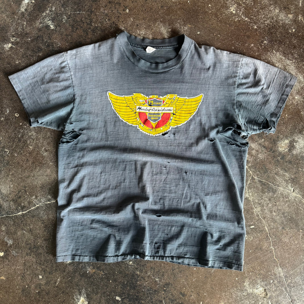 Vintage 1978 Harley-Davidson 75 Years anniversary wings emblem t-shirt thrashed and sun faded to blue grey with holes