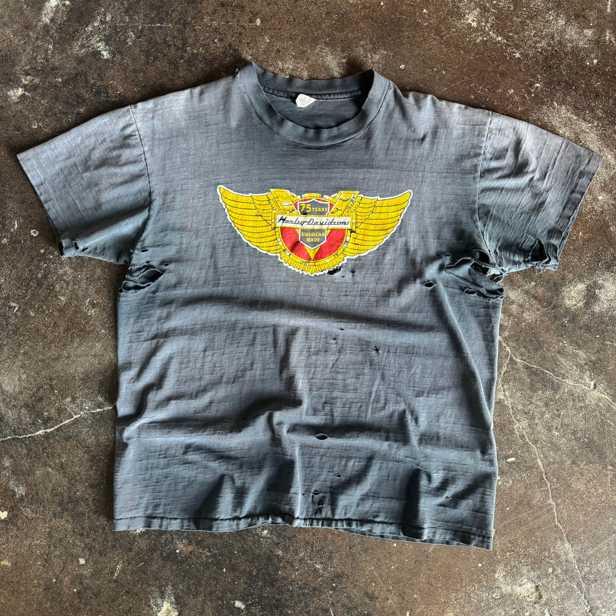 Vintage 1978 Harley-Davidson 75 Years anniversary wings emblem t-shirt thrashed and sun faded to blue grey with holes