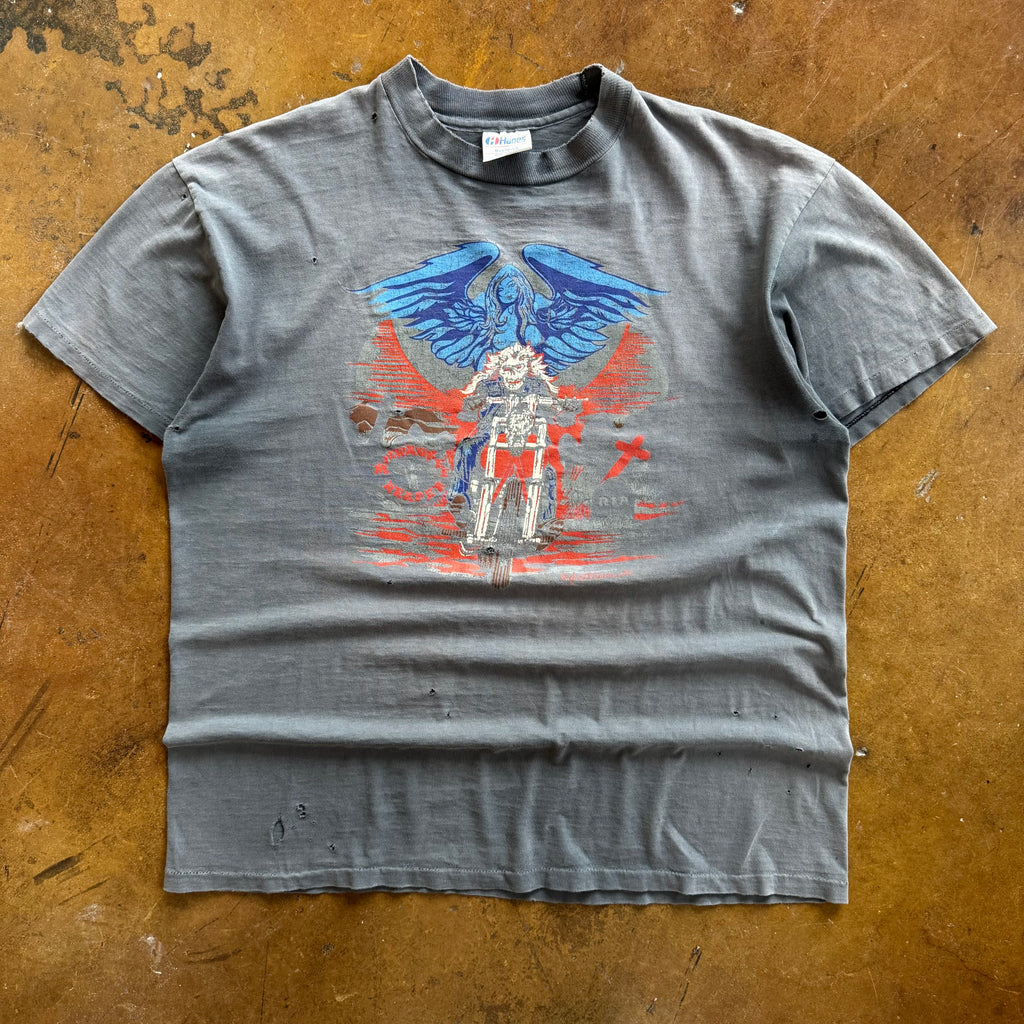 Gray faded short-sleeve t-shirt with centered blue and red reaper graphic with wings on chest