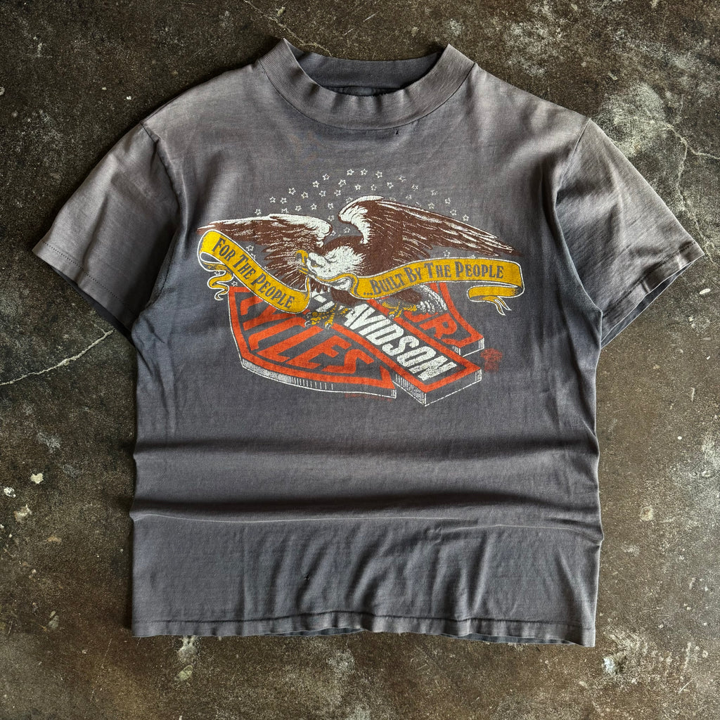 Black short-sleeve t-shirt with eagle graphic and For the People Harley text, sun faded