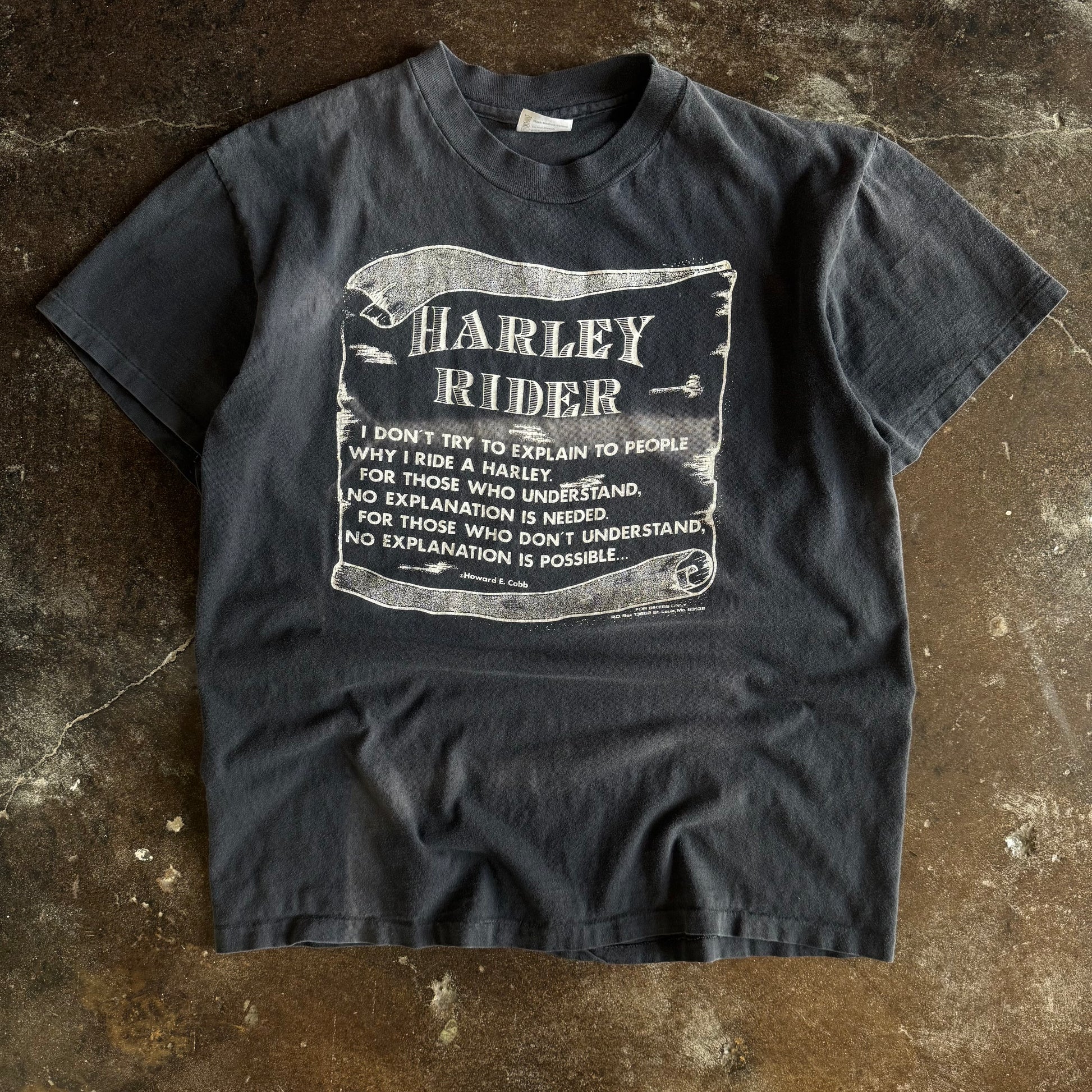 Vintage 1980s Harley Rider scroll banner quote t-shirt sun faded to charcoal with white text graphic
