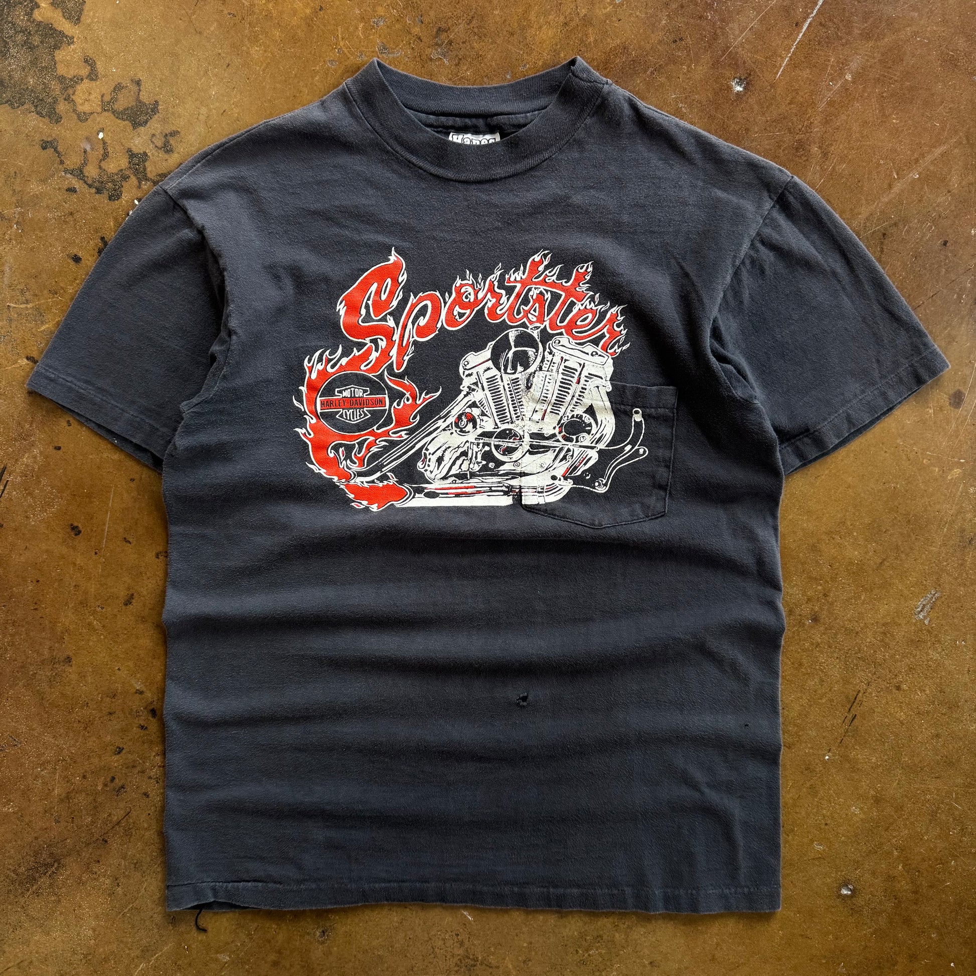 Black short-sleeve t-shirt with red flame graphic on chest pocket area