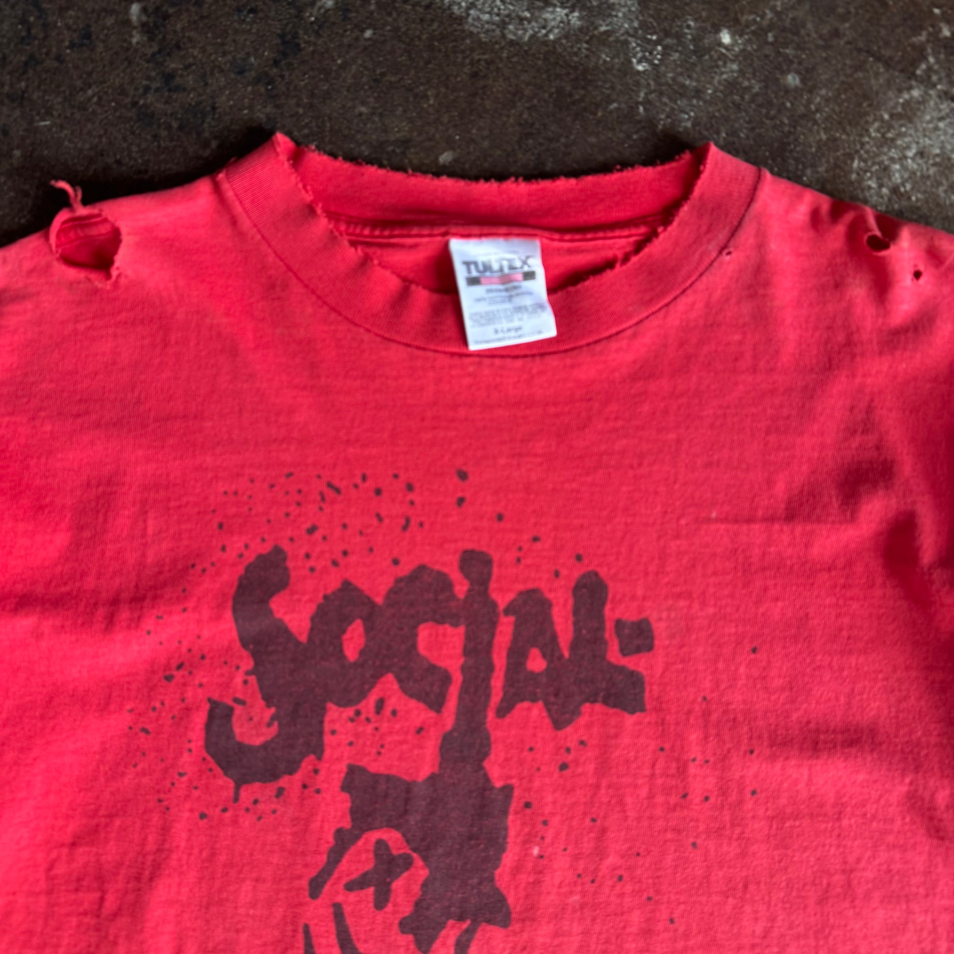 Tag detail on vintage 1990s Social Distortion distressed red band tee